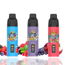 Three colorful CRWN 9K vape devices surrounded by fruit illustrations on a white background.
